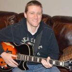 Me holding my Ibanez jazz guitar.
